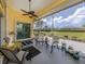 Relaxing screened lanai with comfortable seating, offering scenic views of the backyard and landscaping at 615 May Apple Way, Venice, FL 34293