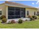Screened lanai perfect for enjoying the outdoors, features a concrete patio and lush landscaping at 615 May Apple Way, Venice, FL 34293