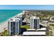 Expansive aerial view of beachfront condos with meticulous landscaping near local attractions at 627 Alhambra Rd # 1103, Venice, FL 34285