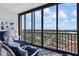 Sunroom balcony with ocean views, comfortable seating, and natural light at 627 Alhambra Rd # 1103, Venice, FL 34285