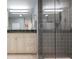Bathroom with a tiled shower, granite counter and vanity with a light color and view into the other room at 627 Alhambra Rd # 1103, Venice, FL 34285