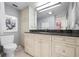 Bright bathroom with vanity, granite counters, commode, large mirror and drawers for storage at 627 Alhambra Rd # 1103, Venice, FL 34285