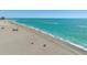 Expansive beach on a sunny day, showing turquoise water and sparse beachgoers enjoying the ocean at 627 Alhambra Rd # 1103, Venice, FL 34285