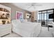 Bright bedroom with a large window and a view, decorated with white furniture at 627 Alhambra Rd # 1103, Venice, FL 34285