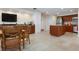 Common area with seating, television, and kitchenette with stainless steel appliances for residents at 627 Alhambra Rd # 1103, Venice, FL 34285