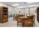 A common area with multiple tables and chairs is well-lit and has multiple windows at 627 Alhambra Rd # 1103, Venice, FL 34285