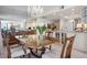 Dining room with chandelier open to the kitchen at 627 Alhambra Rd # 1103, Venice, FL 34285