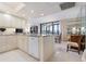 Kitchen with island and view to the dining room at 627 Alhambra Rd # 1103, Venice, FL 34285