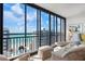 Bright living room with floor-to-ceiling windows and ocean view from the condo at 627 Alhambra Rd # 1103, Venice, FL 34285