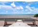 Beautiful ocean view with benches and a shuffle board court in front of the sandy beach at 627 Alhambra Rd # 1103, Venice, FL 34285