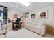 Office space with a white sofa, and a workstation featuring artwork, and great lighting at 627 Alhambra Rd # 1103, Venice, FL 34285