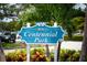Centennial Park sign surrounded by vibrant foliage, providing a welcoming entrance to the local park at 627 Alhambra Rd # 1103, Venice, FL 34285
