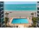 Lovely swimming pool beside the beach with lounge chairs, umbrellas and beautiful landscaping at 627 Alhambra Rd # 1103, Venice, FL 34285