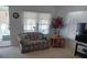 Comfortable living room with plush seating, a TV, and abundant natural light at 638 Leisure, Venice, FL 34285