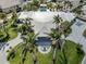 Aerial view of a luxury home featuring meticulously manicured landscaping, a fountain, and a sprawling driveway at 701 Laguna Dr, Venice, FL 34285