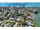 Aerial view featuring a vibrant coastal community with palm-lined streets and a nearby beach at 701 Laguna Dr, Venice, FL 34285
