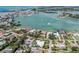Aerial view showcases the bayfront property with lush landscaping and convenient boat access at 701 Laguna Dr, Venice, FL 34285