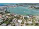Aerial view showcases the bayfront property with lush landscaping and convenient boat access at 701 Laguna Dr, Venice, FL 34285