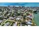 Aerial view featuring a vibrant coastal community with palm-lined streets and a nearby beach at 701 Laguna Dr, Venice, FL 34285