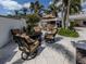 Backyard patio area with comfortable seating, fire pit and outdoor kitchen at 701 Laguna Dr, Venice, FL 34285
