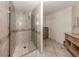 Luxurious bathroom featuring a glass enclosed shower and tile flooring at 701 Laguna Dr, Venice, FL 34285