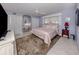 Light-filled bedroom with tile floor, king bed, and ample closet space at 701 Laguna Dr, Venice, FL 34285