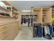 Walk-in closet with custom shelving and drawers provides ample storage space for clothing and accessories at 701 Laguna Dr, Venice, FL 34285