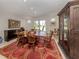 Elegant dining room with wooden table set on red patterned rug and large cabinet at 701 Laguna Dr, Venice, FL 34285