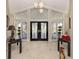 Inviting foyer features sleek tile flooring, soaring ceilings, and double doors at 701 Laguna Dr, Venice, FL 34285