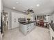 Bright, updated kitchen with large island, modern appliances, and adjacent dining area at 701 Laguna Dr, Venice, FL 34285