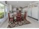 Eat-in kitchen showcases an adjacent wooden table, lots of counter space, and white cabinets at 701 Laguna Dr, Venice, FL 34285