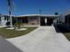 Cozy home featuring a carport and a well maintained yard at 722 Carefree, Venice, FL 34285