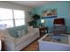 Cozy living room with a sofa, artwork, and natural light at 722 Carefree, Venice, FL 34285
