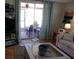 Comfortable living room with a sliding glass door, sofa, and television at 722 Carefree, Venice, FL 34285