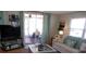 Cozy living room featuring a sliding glass door leading to screened porch at 722 Carefree, Venice, FL 34285