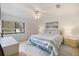 Bright bedroom with a queen bed, ceiling fan, and large window with natural light at 758 Bird Bay W Dr # 169, Venice, FL 34285