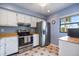 Bright kitchen with stainless steel appliances, white cabinetry, and a window offering natural light at 758 Bird Bay W Dr # 169, Venice, FL 34285