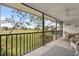 Screened-in lanai featuring tiled flooring, ceiling fan, and scenic views at 758 Bird Bay W Dr # 169, Venice, FL 34285