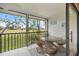 Covered lanai with chairs and a table and views of the community at 758 Bird Bay W Dr # 169, Venice, FL 34285