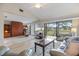 Spacious living room with ample natural light, patio access, and comfortable furnishings at 758 Bird Bay W Dr # 169, Venice, FL 34285