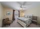 Bedroom features a ceiling fan, comfortable queen bed, and a large window that offers great natural light at 764 Avenida Estancia # 212, Venice, FL 34292