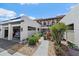 Townhouse exterior featuring stucco facade, carport, and lush landscaping at 764 Avenida Estancia # 212, Venice, FL 34292