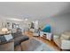 Open-concept living room with ceiling fan, wood floors, and neutral decor at 764 Avenida Estancia # 212, Venice, FL 34292