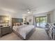 Comfortable bedroom with plush carpet, pond views, and ample closet space at 764 Avenida Estancia # 212, Venice, FL 34292