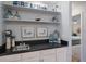 Stylish wet bar featuring sink, storage, and decor at 764 Avenida Estancia # 212, Venice, FL 34292