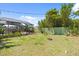 The fenced backyard includes a screened pool, patio area, mature trees, and well-maintained lawn at 888 Kimball Rd, Venice, FL 34293