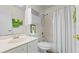 Bright bathroom featuring a shower, toilet, and vanity with a mirror at 888 Kimball Rd, Venice, FL 34293