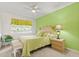 Bright bedroom featuring light green walls, wood furnishings, and tiled floor at 888 Kimball Rd, Venice, FL 34293