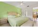 Bright bedroom featuring light green walls, wood furnishings, and tiled floor at 888 Kimball Rd, Venice, FL 34293