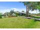 Well-maintained home featuring a large grassy front yard and mature shade trees at 888 Kimball Rd, Venice, FL 34293